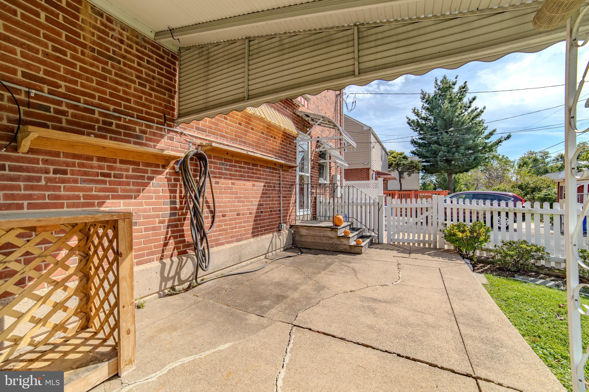304 Earlington Road Havertown, PA 19083 - Photo 20 of 26 a view of a patio with table and chairs and wooden fence