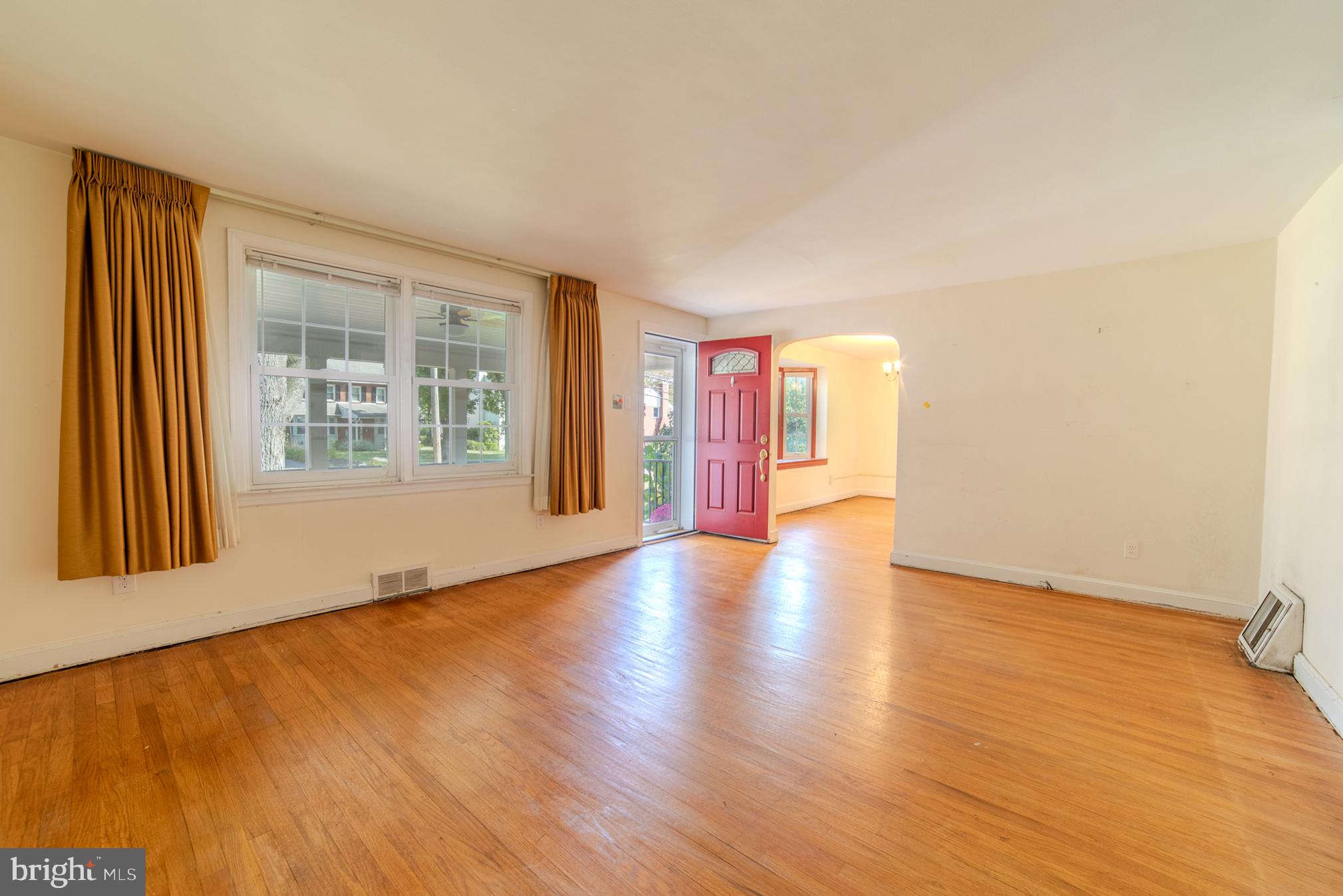 304 Earlington Road Havertown, PA 19083 - Photo 3 of 26 a view of an empty room with a window and wooden floor