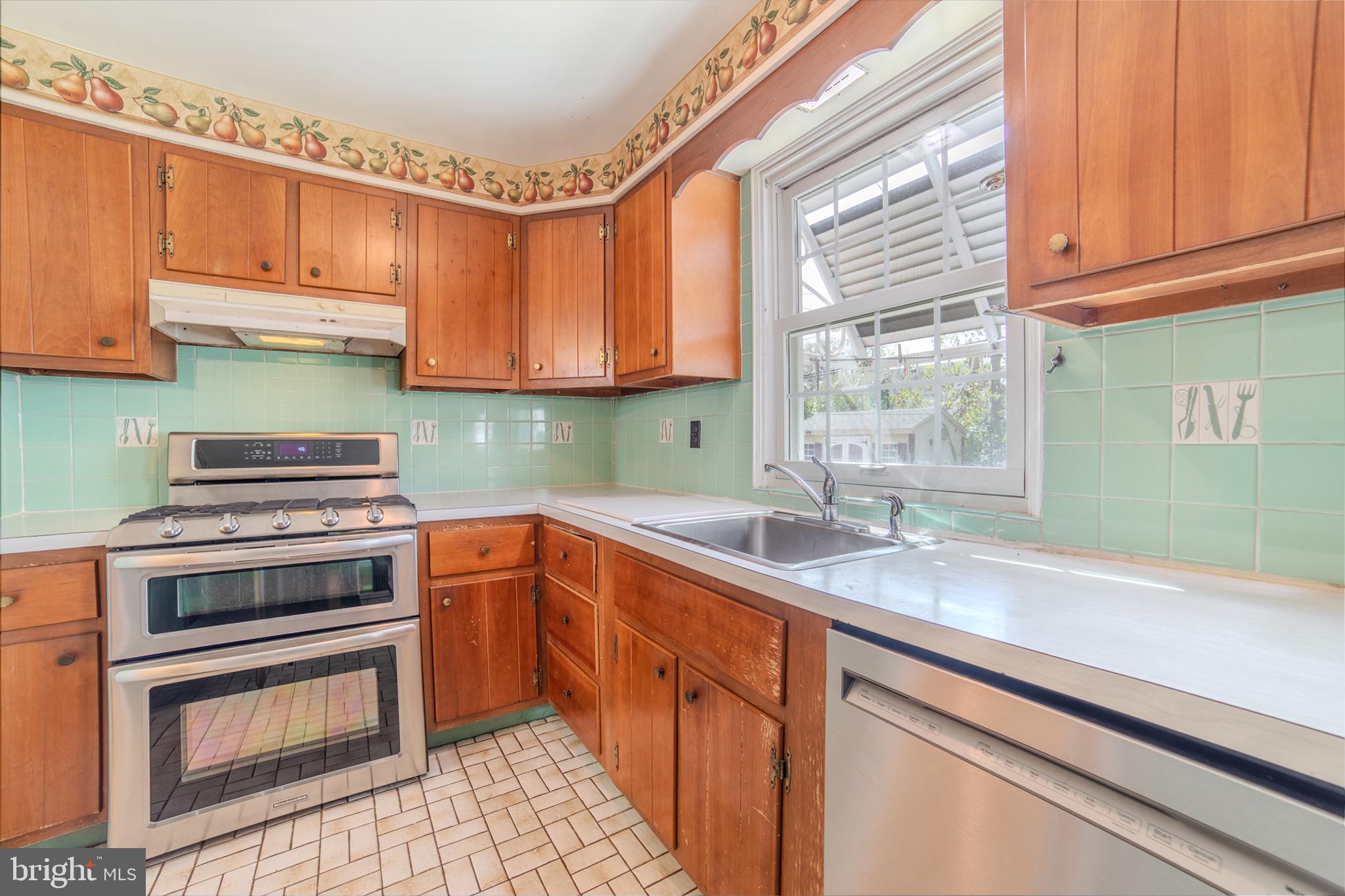 304 Earlington Road Havertown, PA 19083 - Photo 7 of 26 a kitchen with stainless steel appliances granite countertop a sink a stove and a microwave