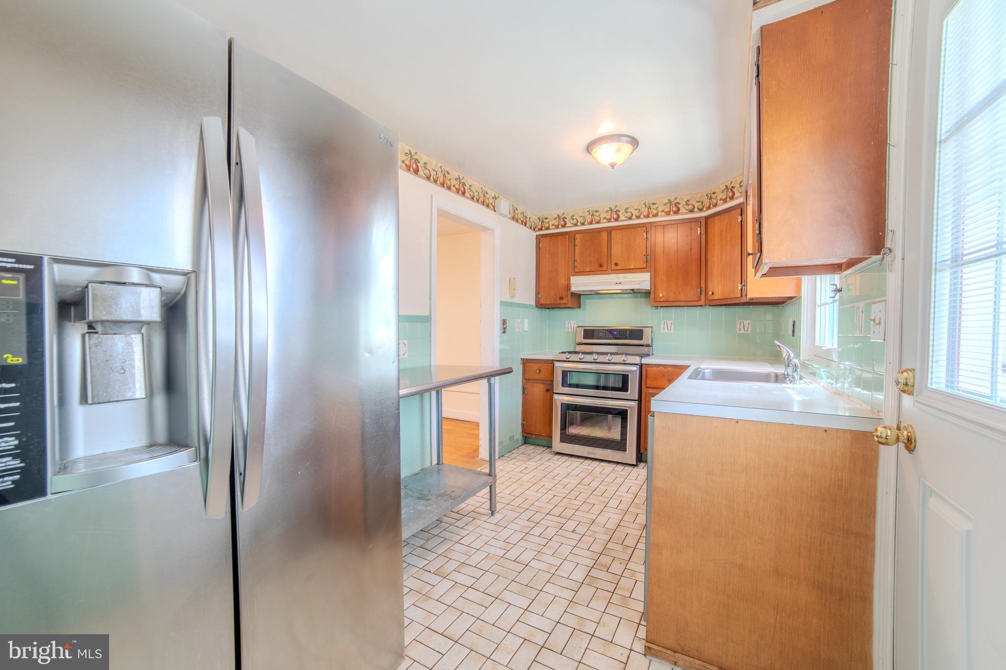 304 Earlington Road Havertown, PA 19083 - Photo 8 of 26 a kitchen with granite countertop a refrigerator and a stove top oven