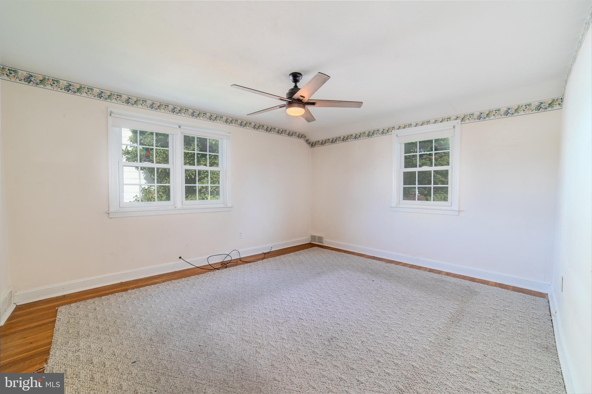 304 Earlington Road Havertown, PA 19083 - Photo 10 of 26 an empty room with windows and ceiling fan