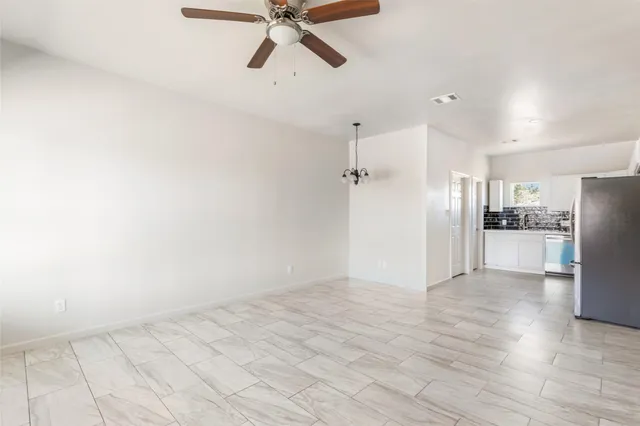 a view of a kitchen with a sink and refrigerator