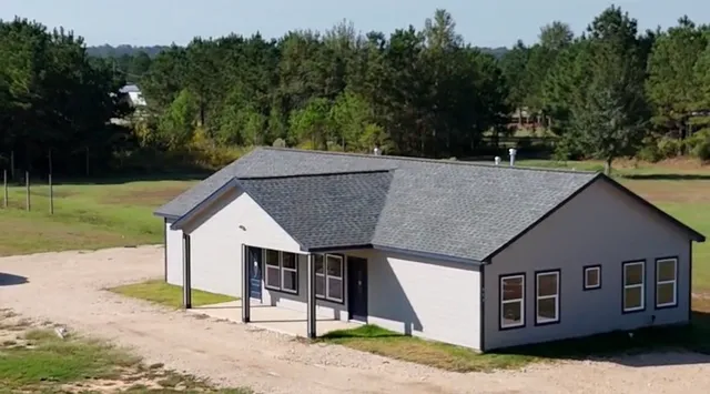a house with trees in the background