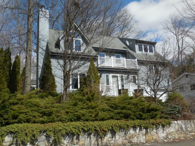 a front view of house with a garden