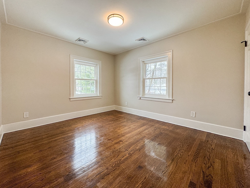 51 Westfield Road Warwick, RI 02888 - Photo 23 of 31 an empty room with wooden floor and windows