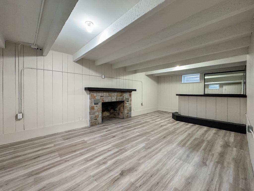 51 Westfield Road Warwick, RI 02888 - Photo 27 of 31 a view of empty room with wooden floor and fireplace