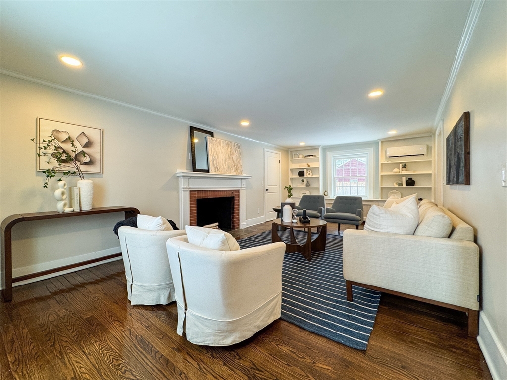 51 Westfield Road Warwick, RI 02888 - Photo 6 of 31 a living room with furniture a fireplace and a table
