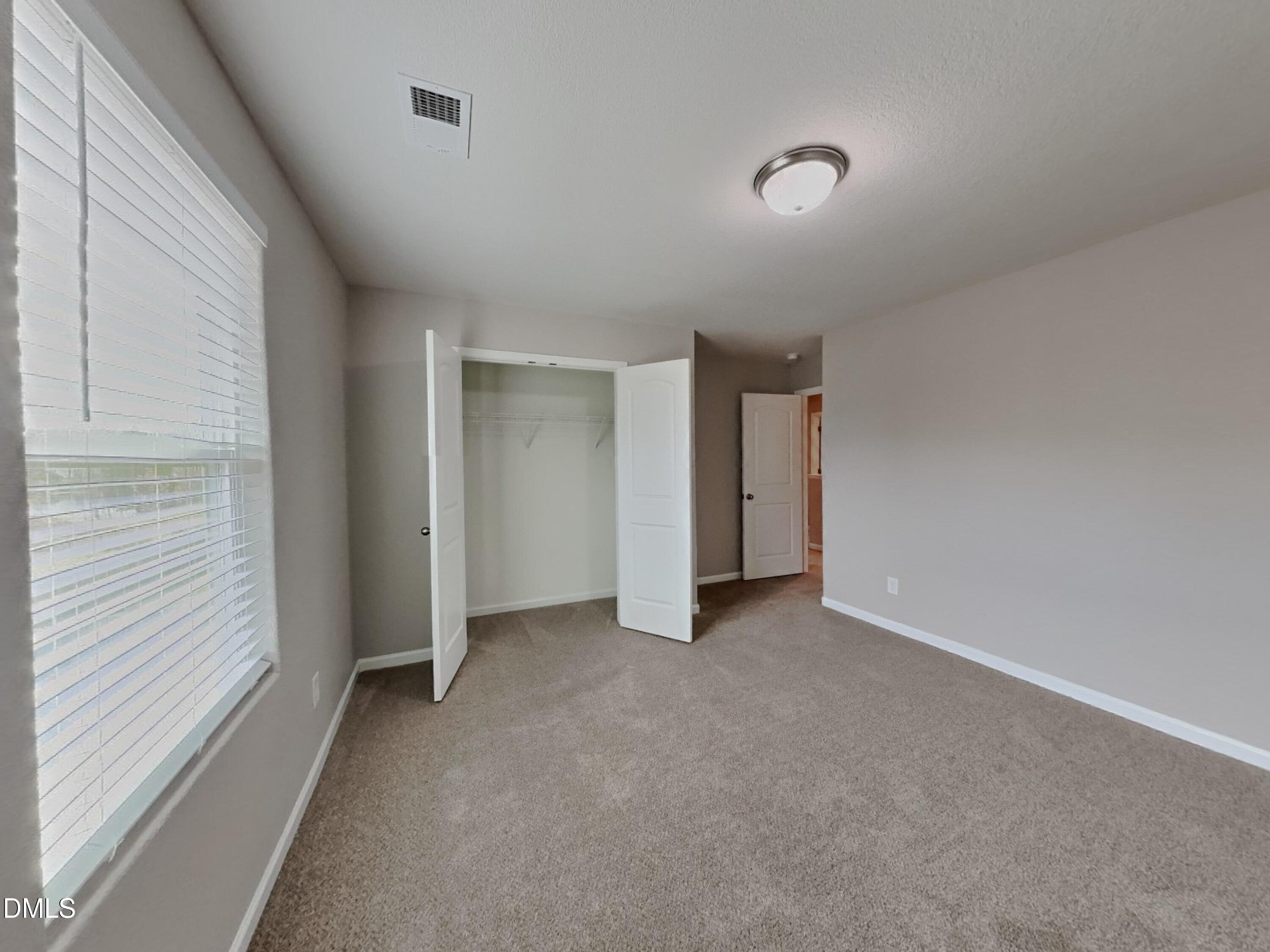 784 Frosty Way Zebulon, NC 27597 - Photo 11 of 15 a view of an empty room with a window