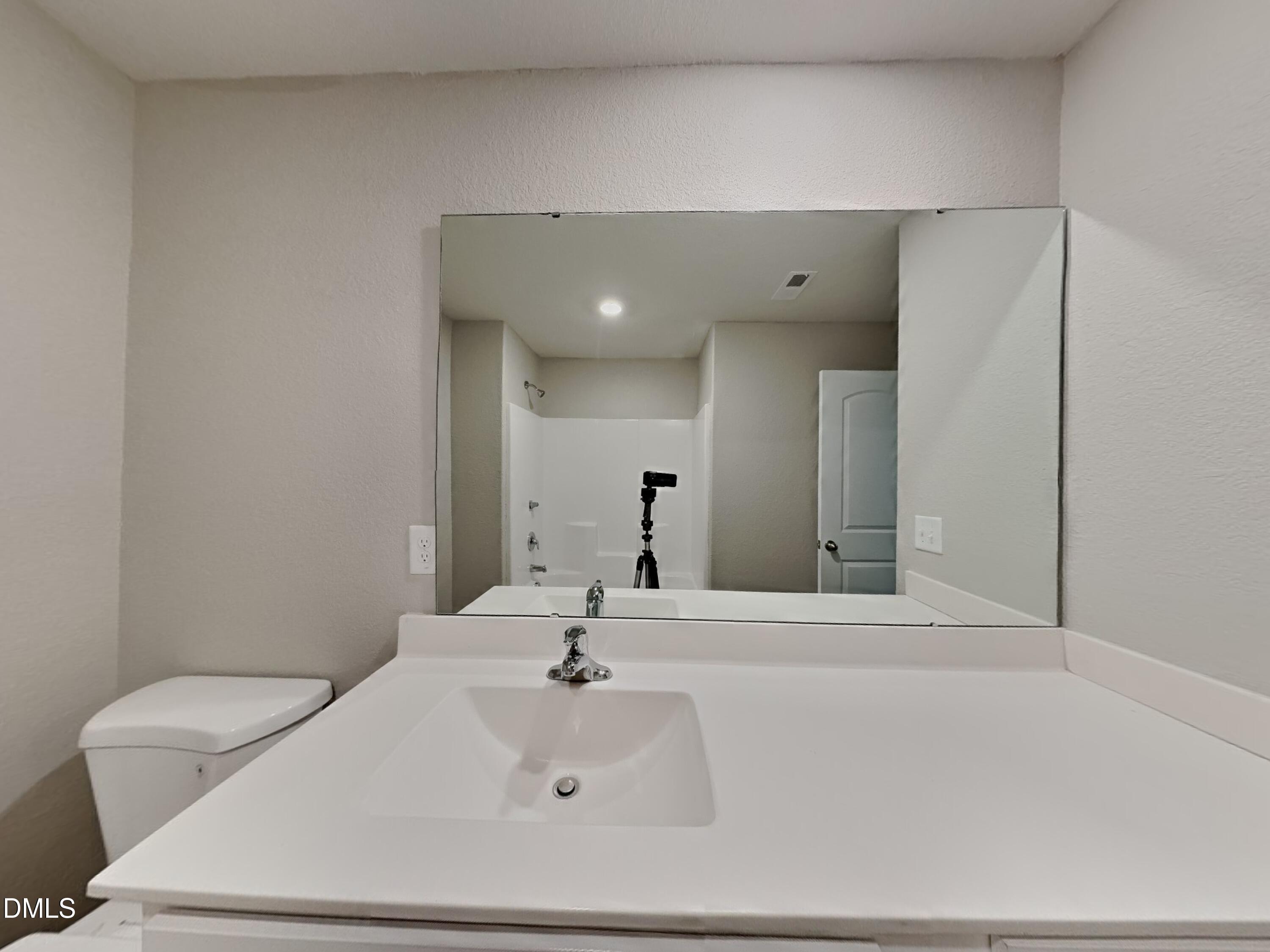 784 Frosty Way Zebulon, NC 27597 - Photo 13 of 15 a bathroom with a sink and a mirror
