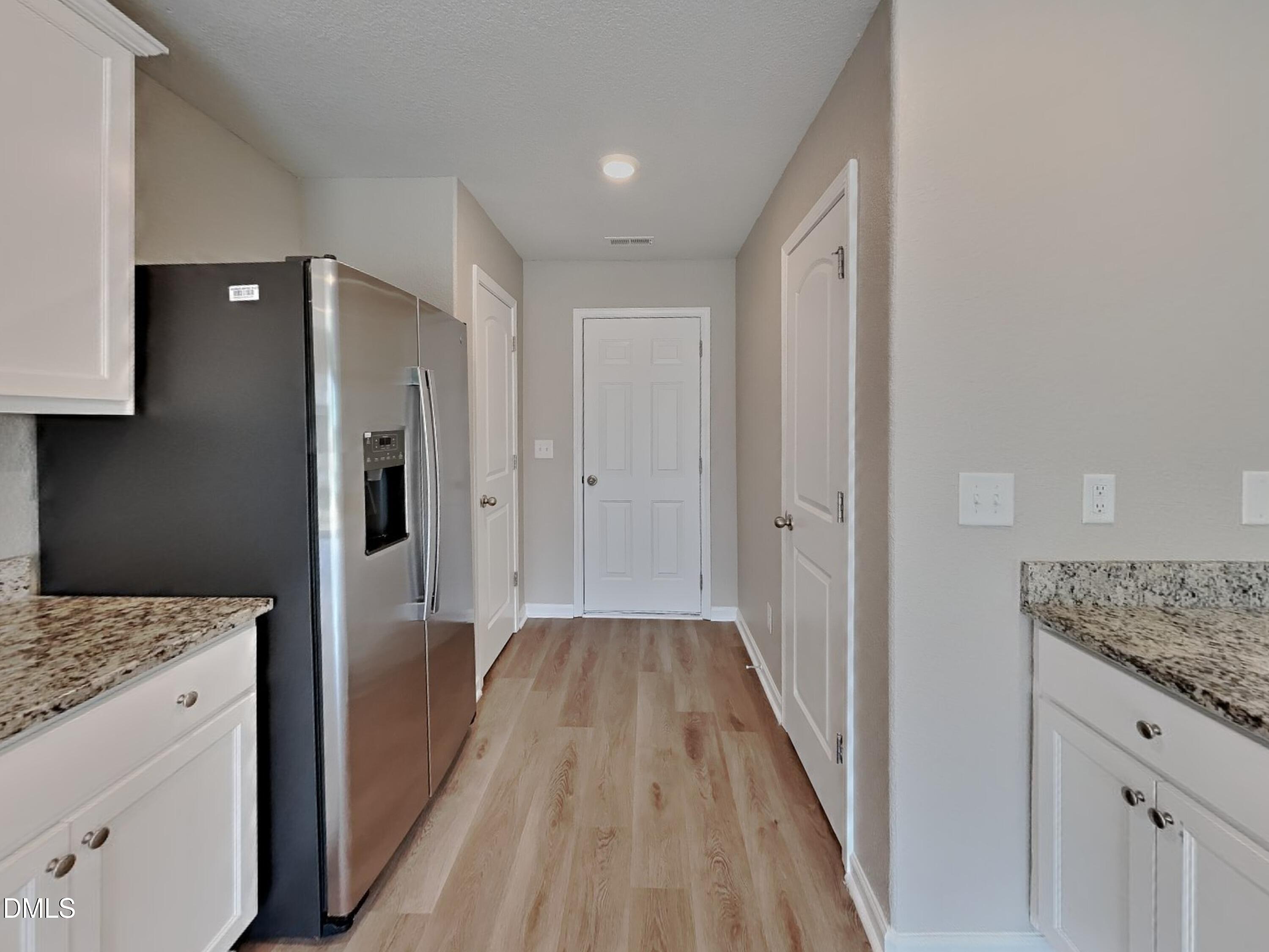 784 Frosty Way Zebulon, NC 27597 - Photo 5 of 15 a view of a kitchen cabinets and wooden floor