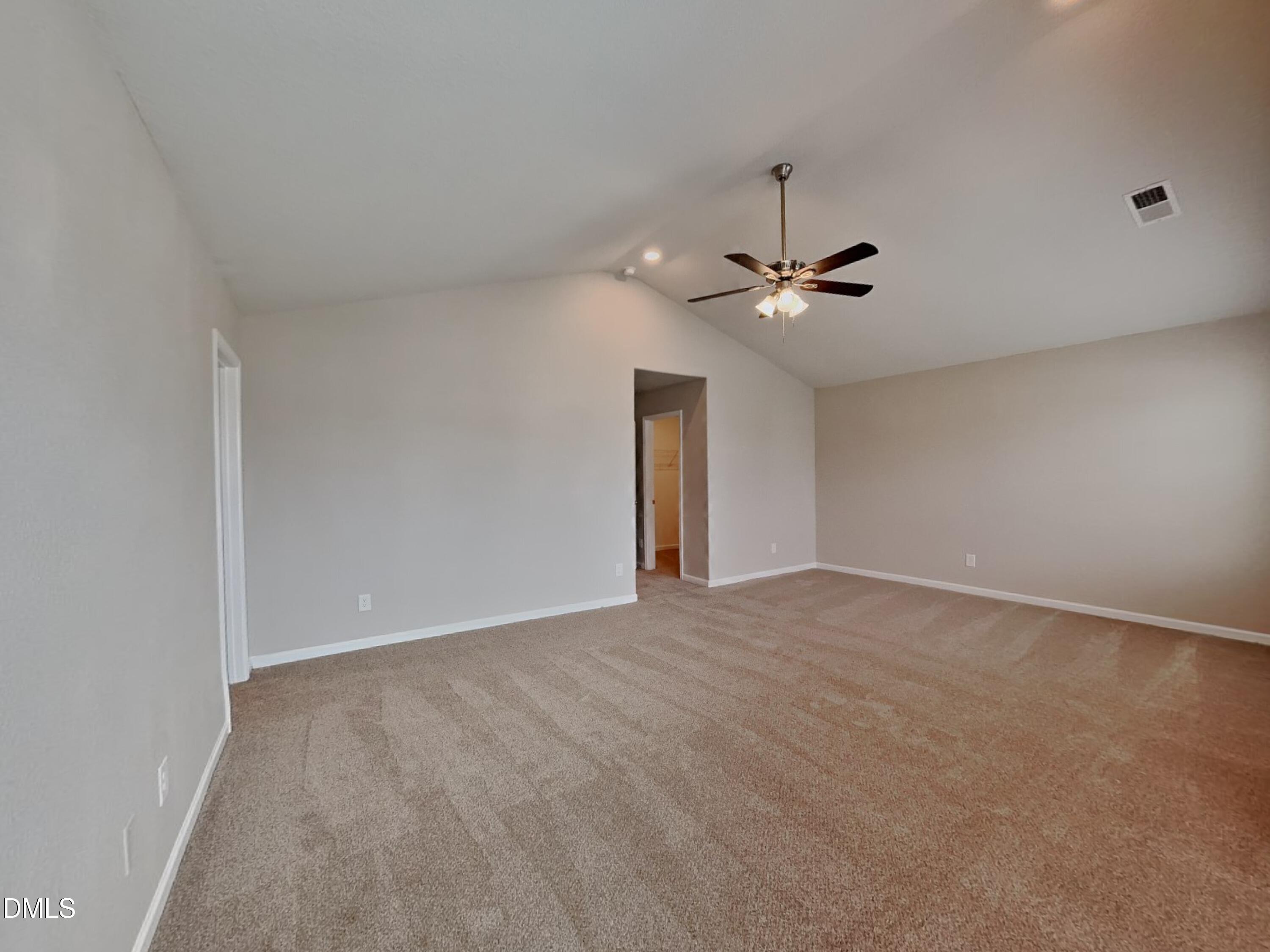 784 Frosty Way Zebulon, NC 27597 - Photo 6 of 15 a view of an empty room with a ceiling fan