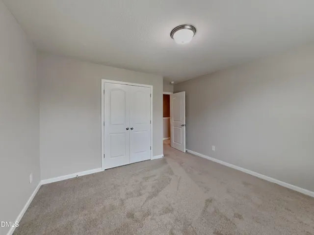 a view of an empty room and a window