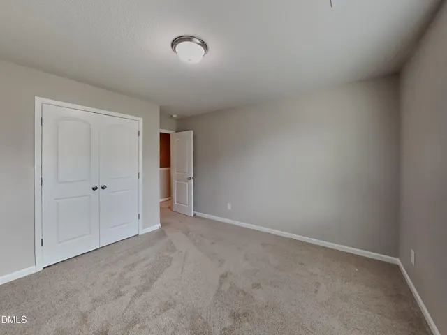 a view of an empty room and closet area