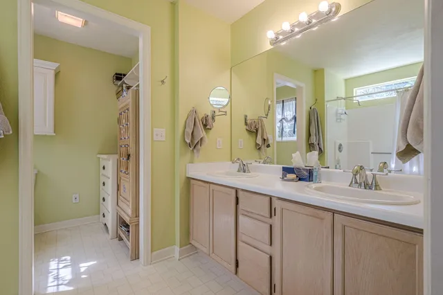 a bathroom with a double vanity sink mirror and double