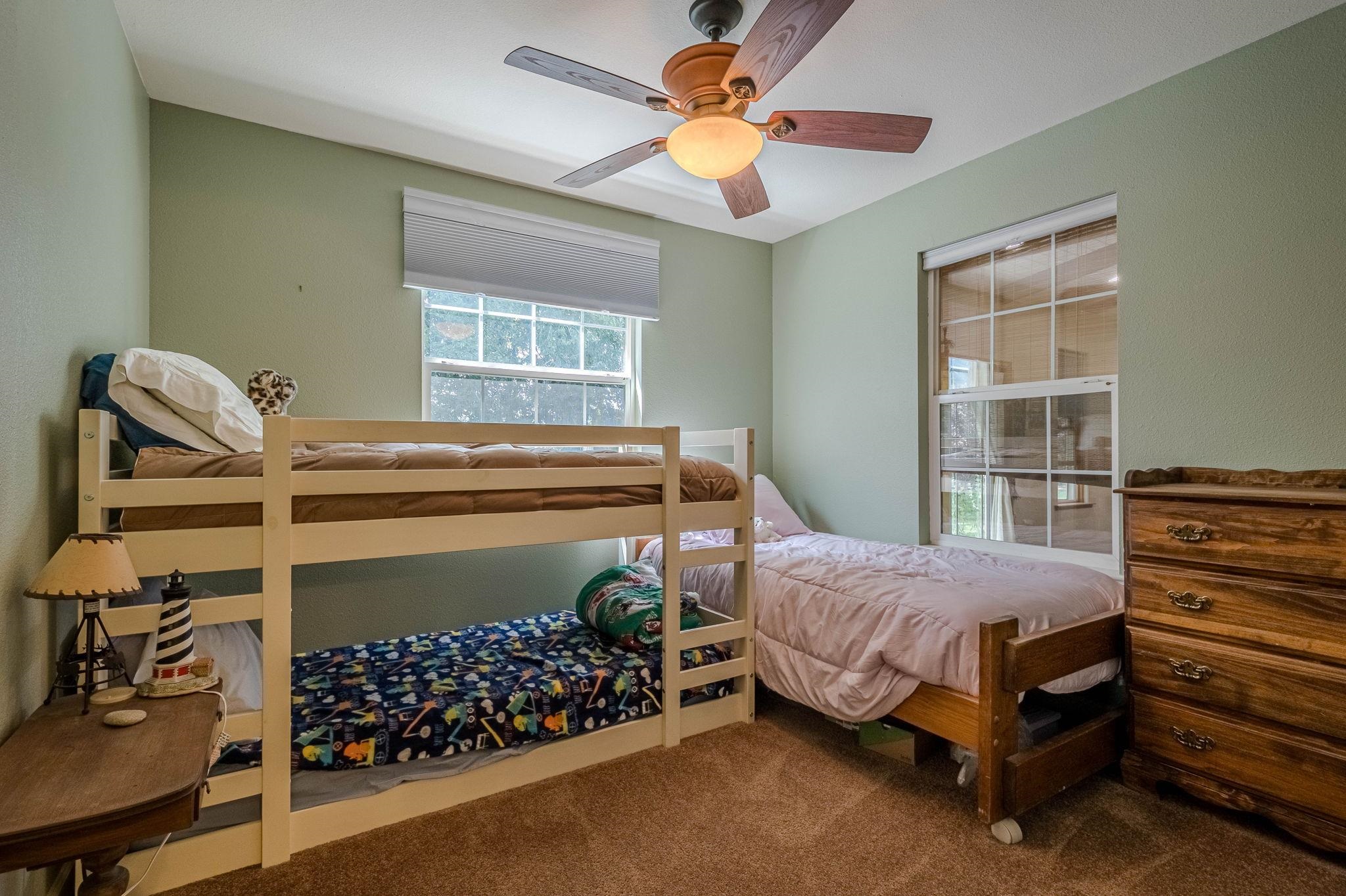 3613 G Road, Unit E Palisade, CO 81526 - Photo 16 of 42 a bed room with a bed chair and a window