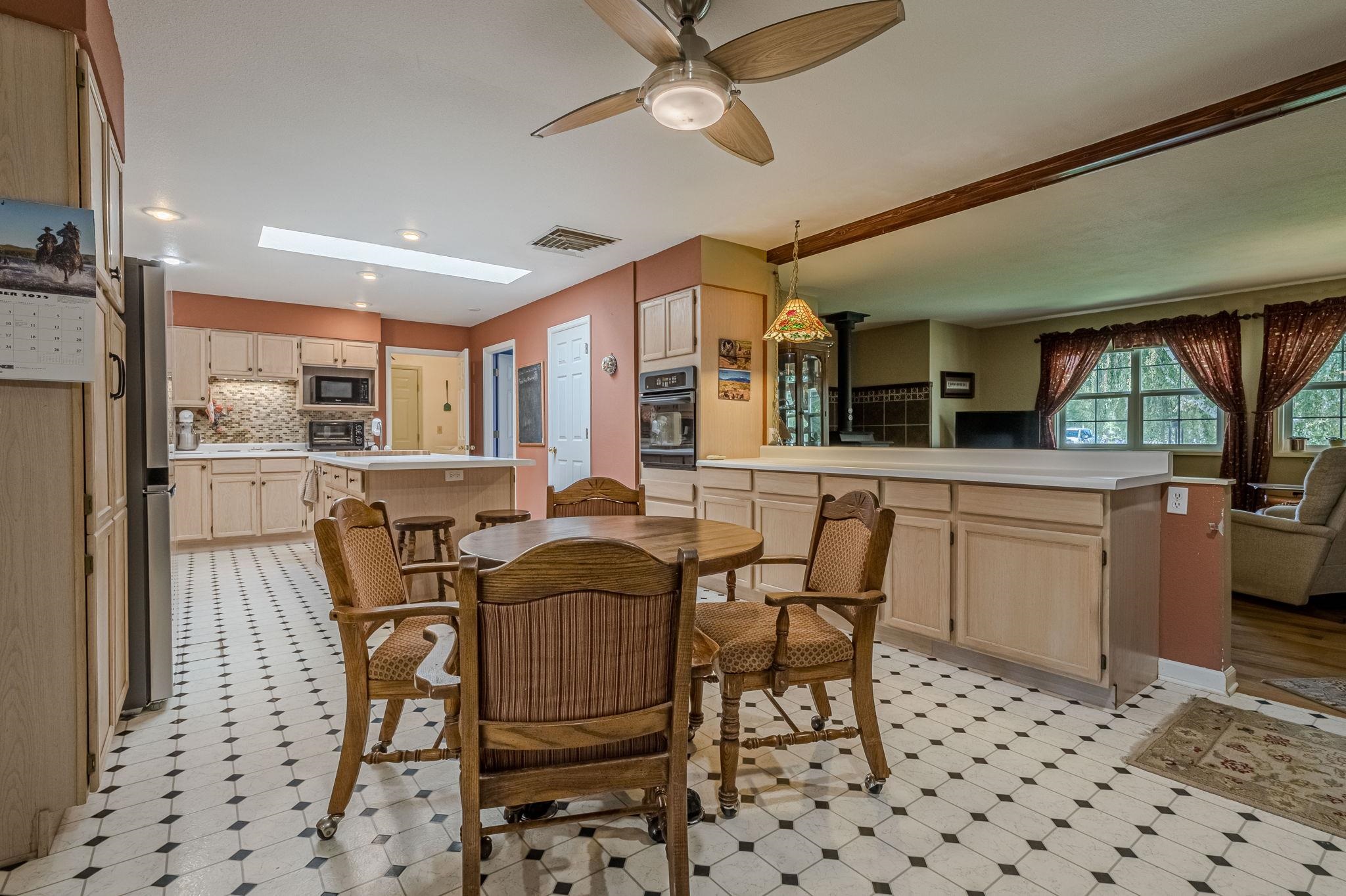 3613 G Road, Unit E Palisade, CO 81526 - Photo 19 of 42 a dining hall with stainless steel appliances a dining table and chairs