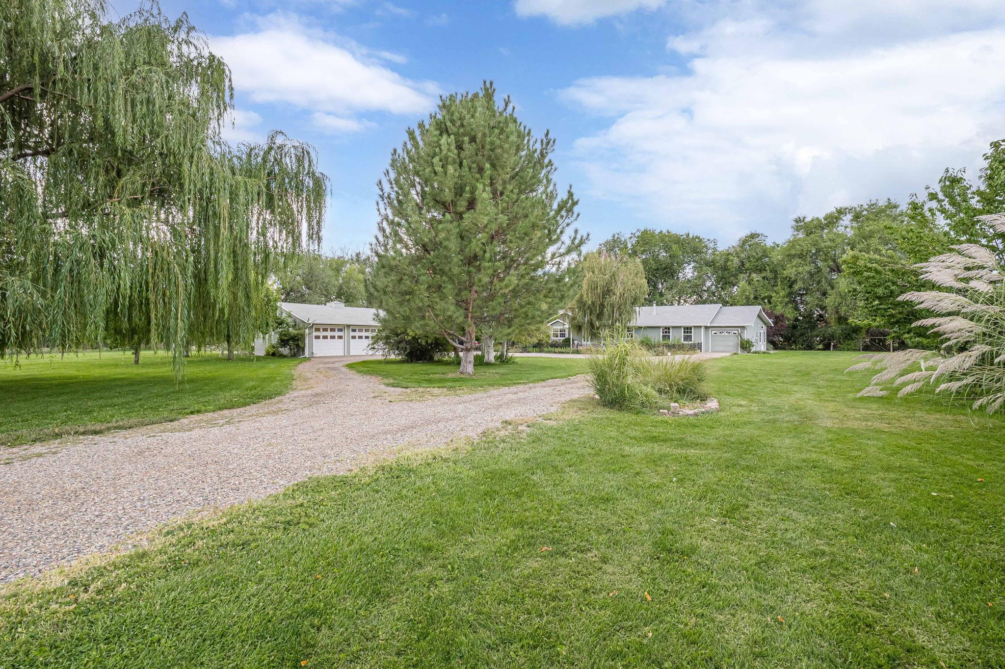 3613 G Road, Unit E Palisade, CO 81526 - Photo 2 of 42 a yellow and red house with a garden