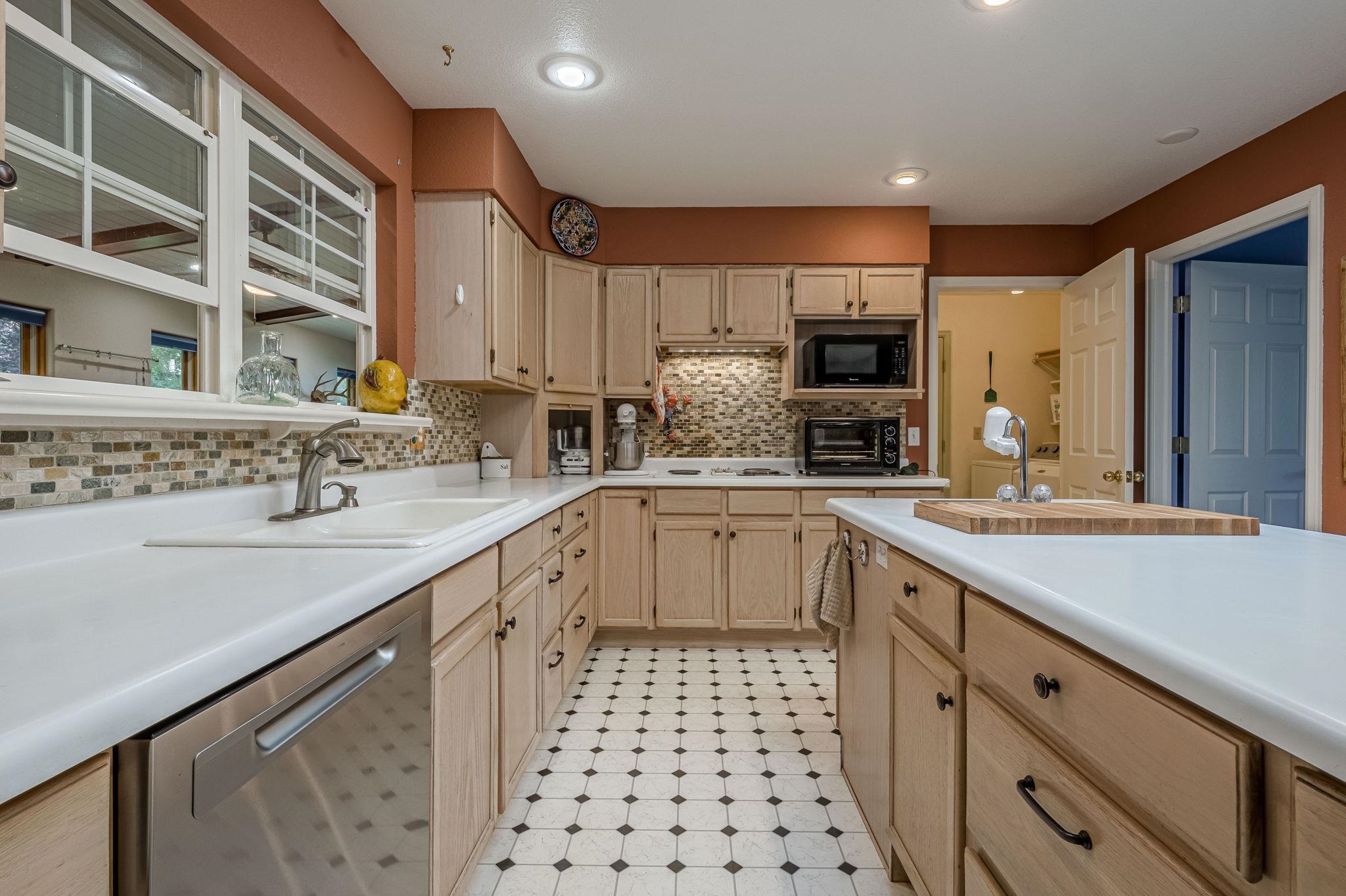 3613 G Road, Unit E Palisade, CO 81526 - Photo 21 of 42 a kitchen with a sink stove and cabinets