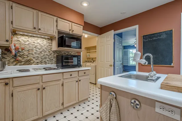 a kitchen with a sink stove and cabinets