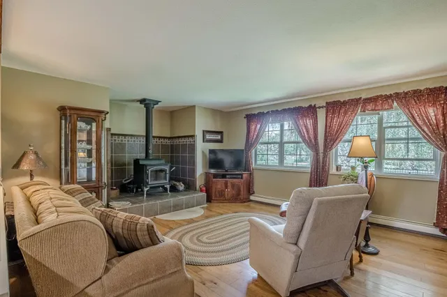 a living room with furniture a window and a flat screen tv