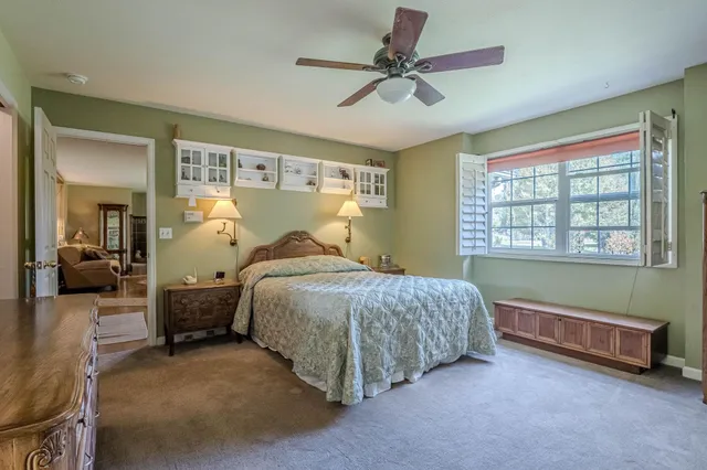 a bed room with a bed and a large window