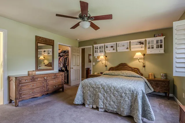 a bedroom with a bed and dresser
