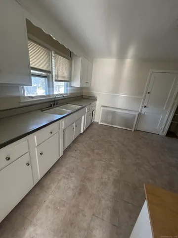 a kitchen with cabinets and window