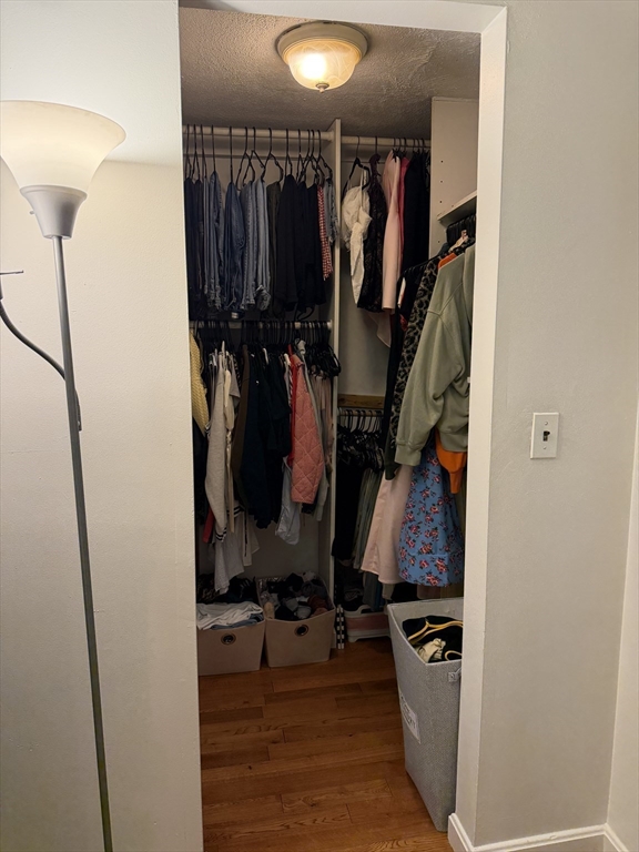 32 Fleet Street, Unit B Boston, MA 02113 - Photo 6 of 7 a view of walk in closet with clothes and shoes