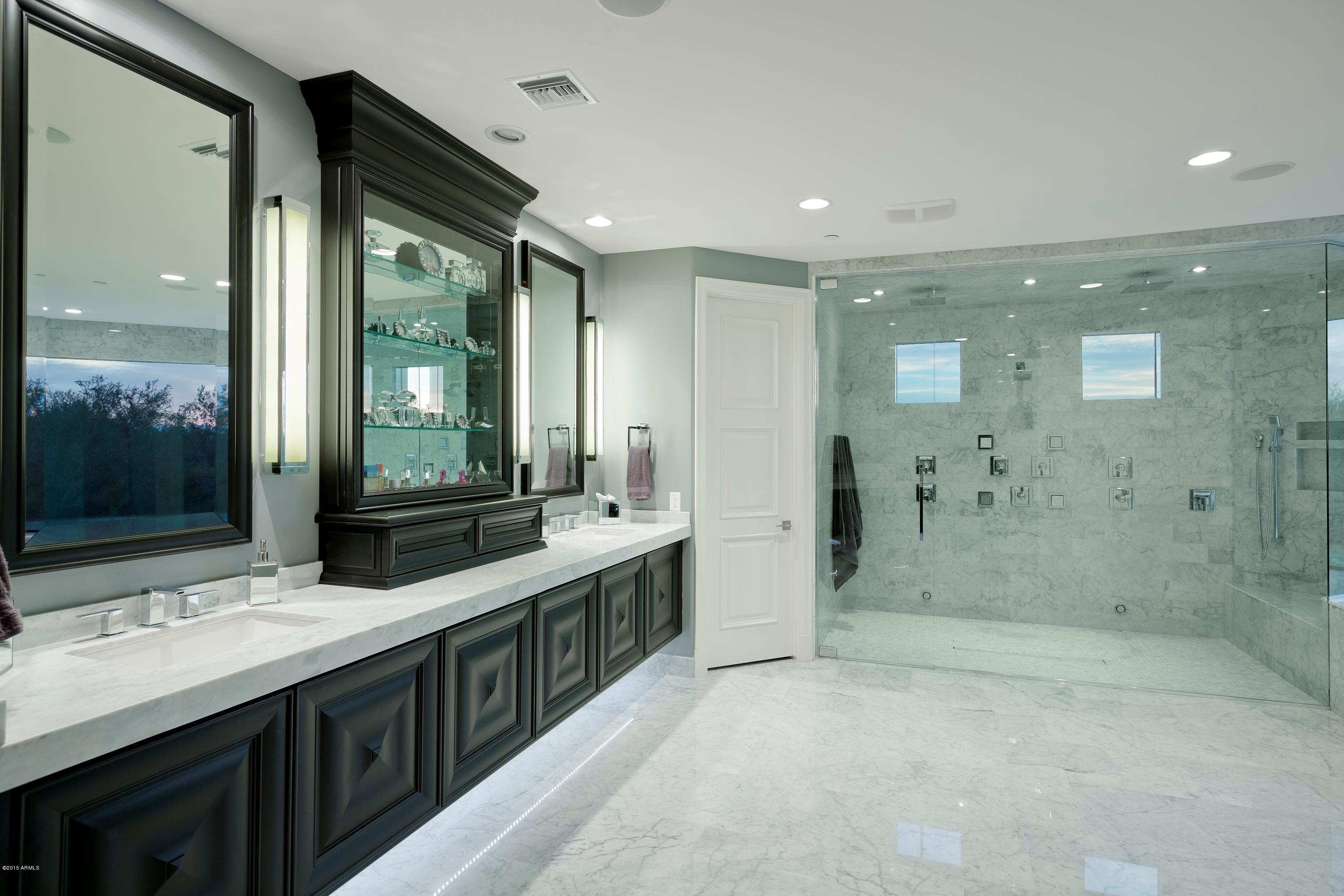 10040 East Happy Valley Road, Unit 14 Scottsdale, AZ 85255 - Photo 12 of 21 a bathroom with a granite countertop sink mirror and shower