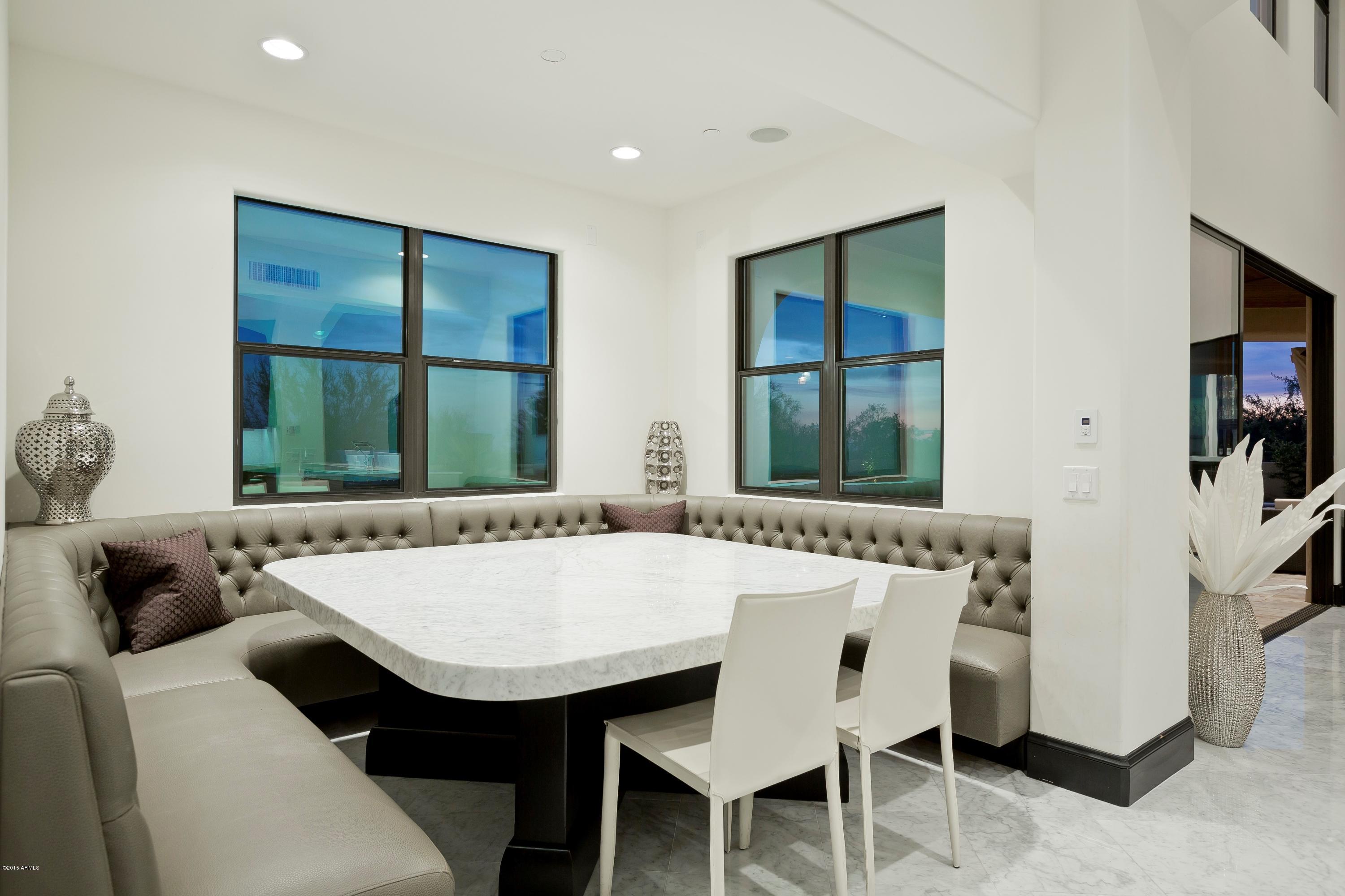 10040 East Happy Valley Road, Unit 14 Scottsdale, AZ 85255 - Photo 9 of 21 a view of a dining room with furniture and window