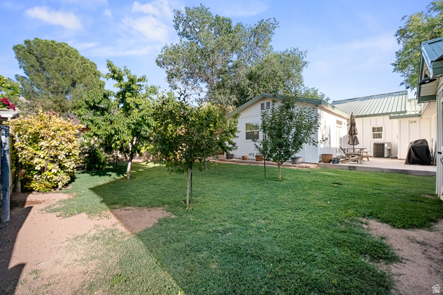 236 West 300 South Hurricane, UT 84737 - Photo 67 of 76 Expansive lawn area featuring mature trees and a paved patio