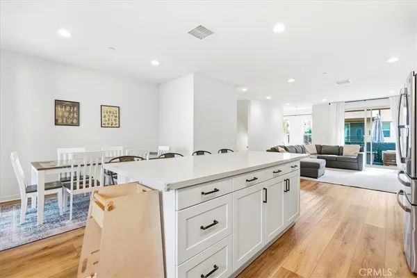a large white kitchen with a large window