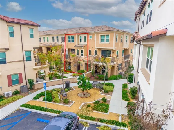 an aerial view of residential houses with outdoor space and ocean view