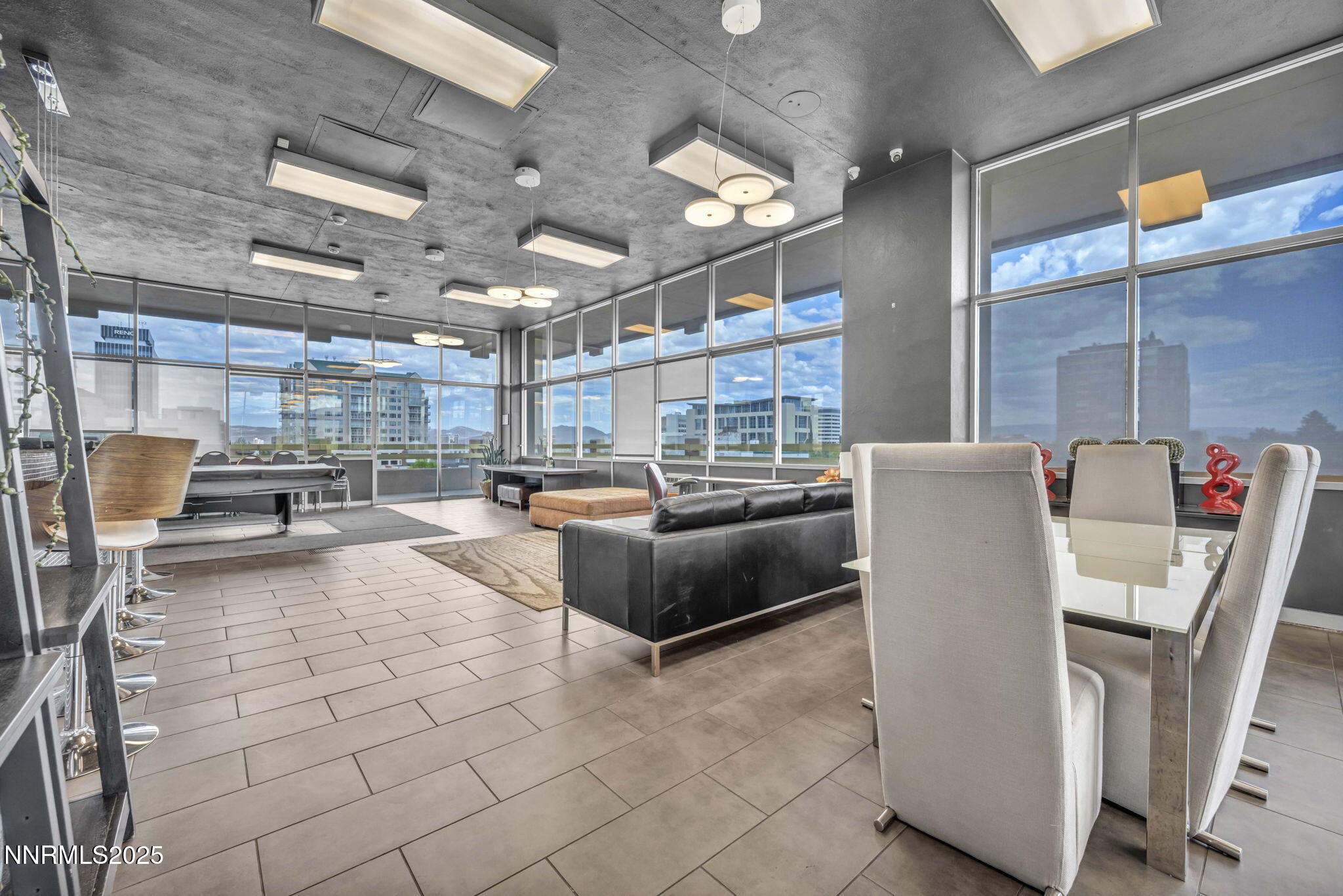 100 North Arlington Avenue, Unit 22C Reno, NV 89501 - Photo 27 of 34 a living room with furniture a flat screen tv and a table