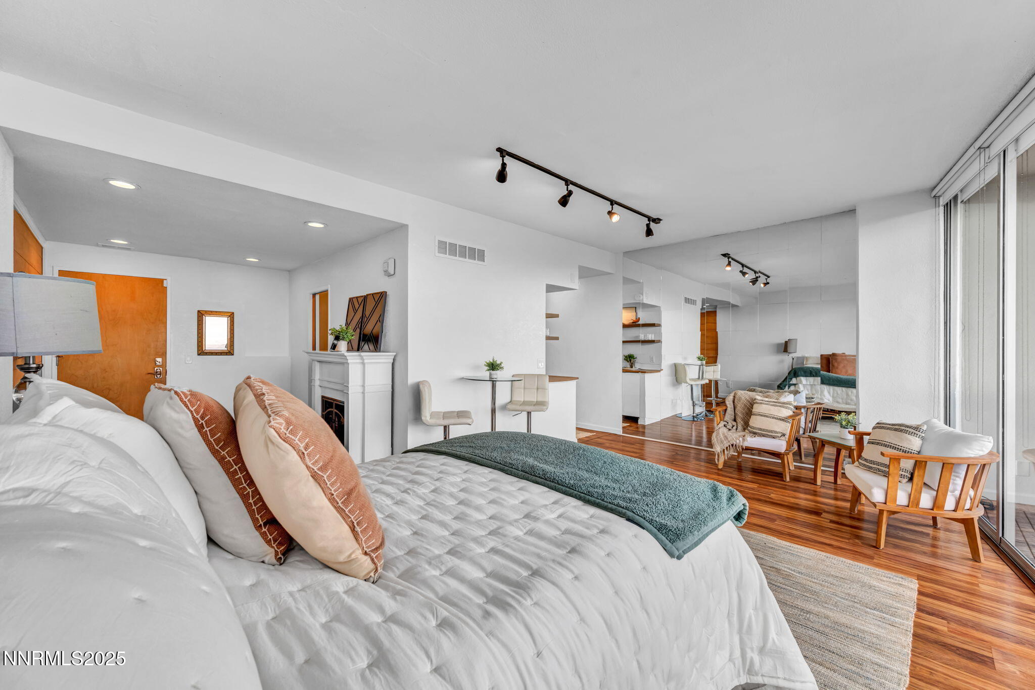 100 North Arlington Avenue, Unit 22C Reno, NV 89501 - Photo 5 of 34 a bed room with a bed and a chair