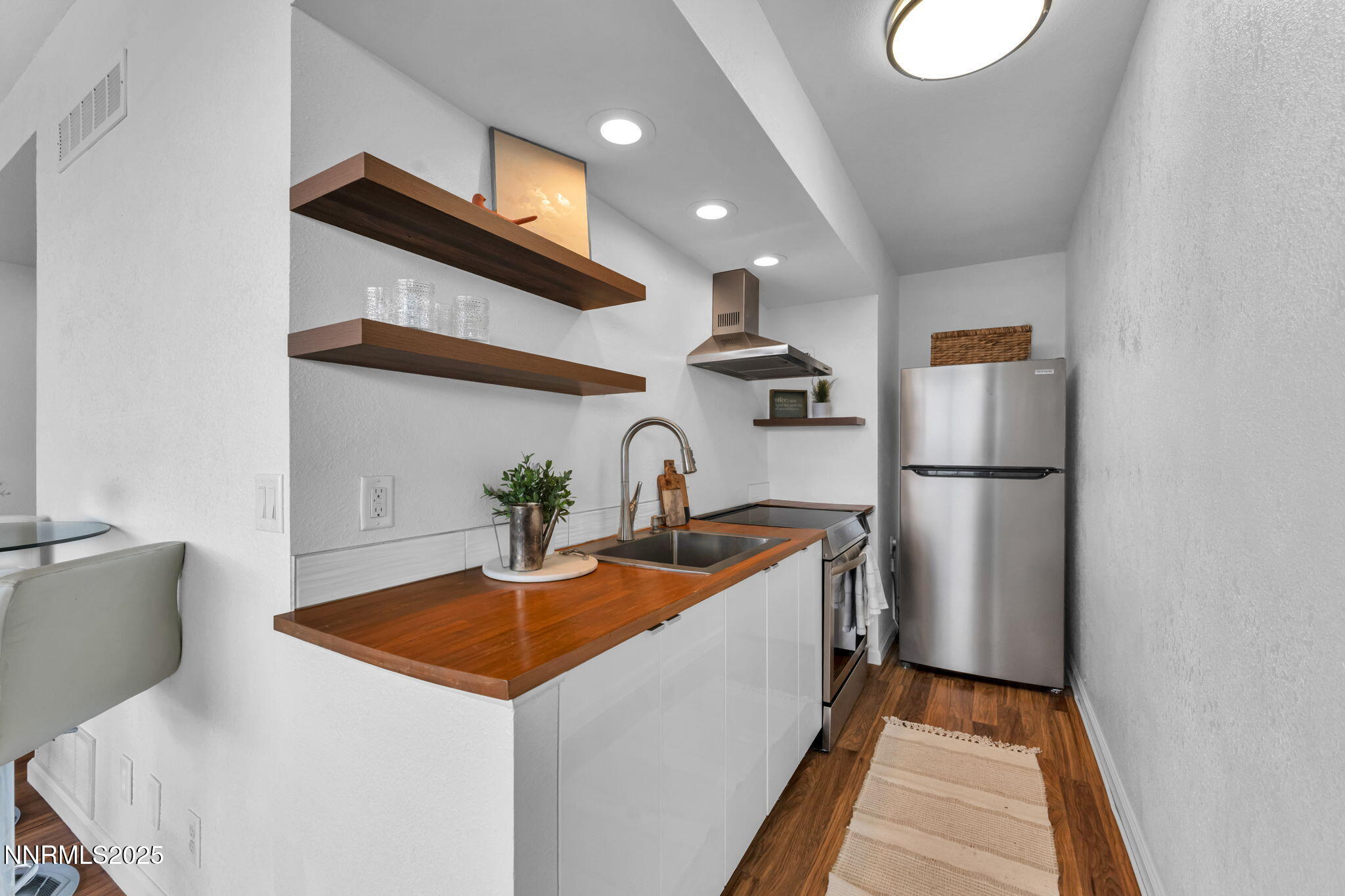 100 North Arlington Avenue, Unit 22C Reno, NV 89501 - Photo 8 of 34 a kitchen with stainless steel appliances granite countertop a sink and a refrigerator