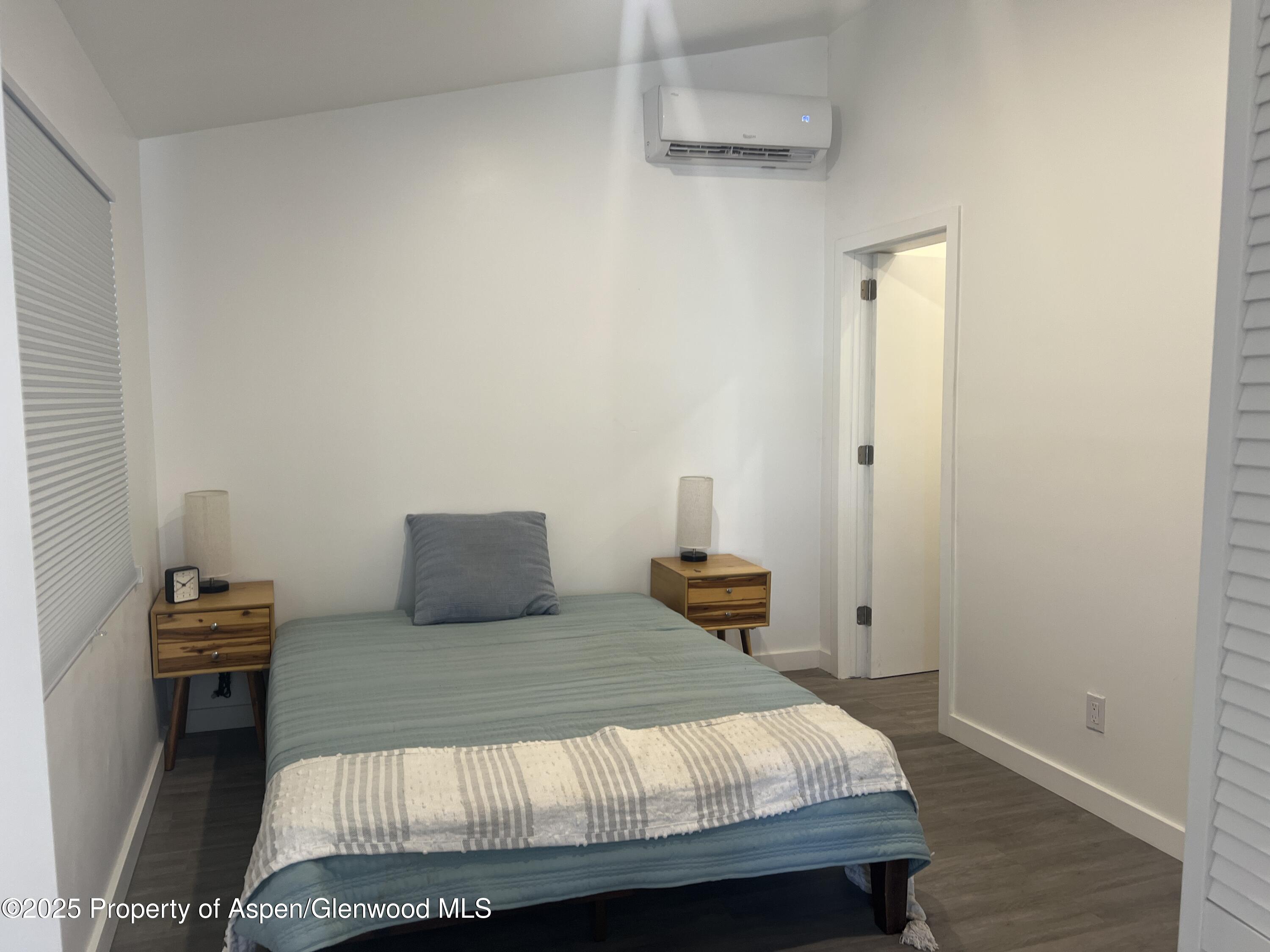 282 Cowboy Drive Rifle, CO 81650 - Photo 6 of 13 a bedroom with a bed and wooden floor