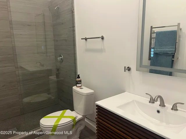 a bathroom with a sink toilet and shower