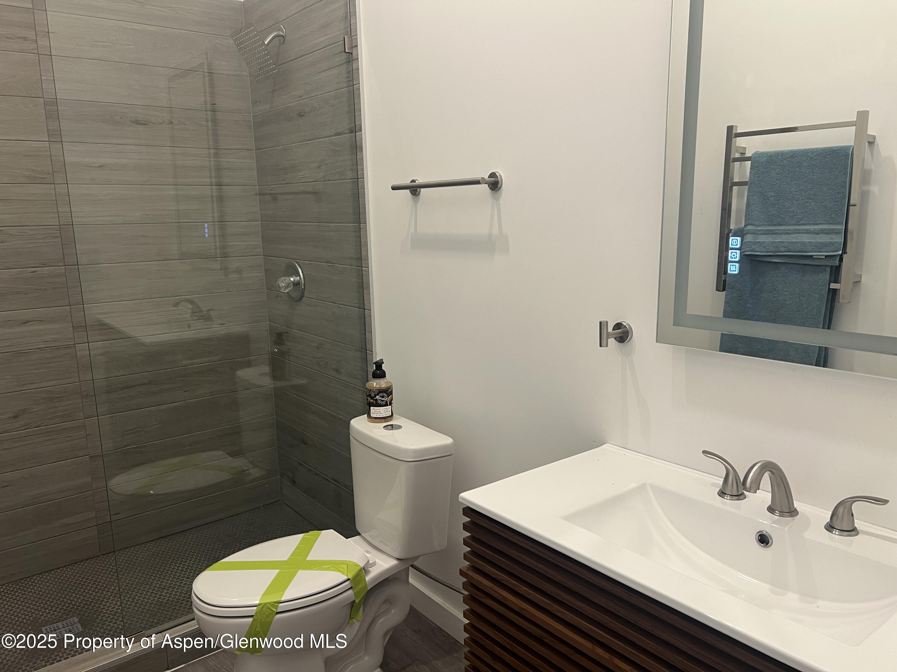282 Cowboy Drive Rifle, CO 81650 - Photo 7 of 13 a bathroom with a sink toilet and shower
