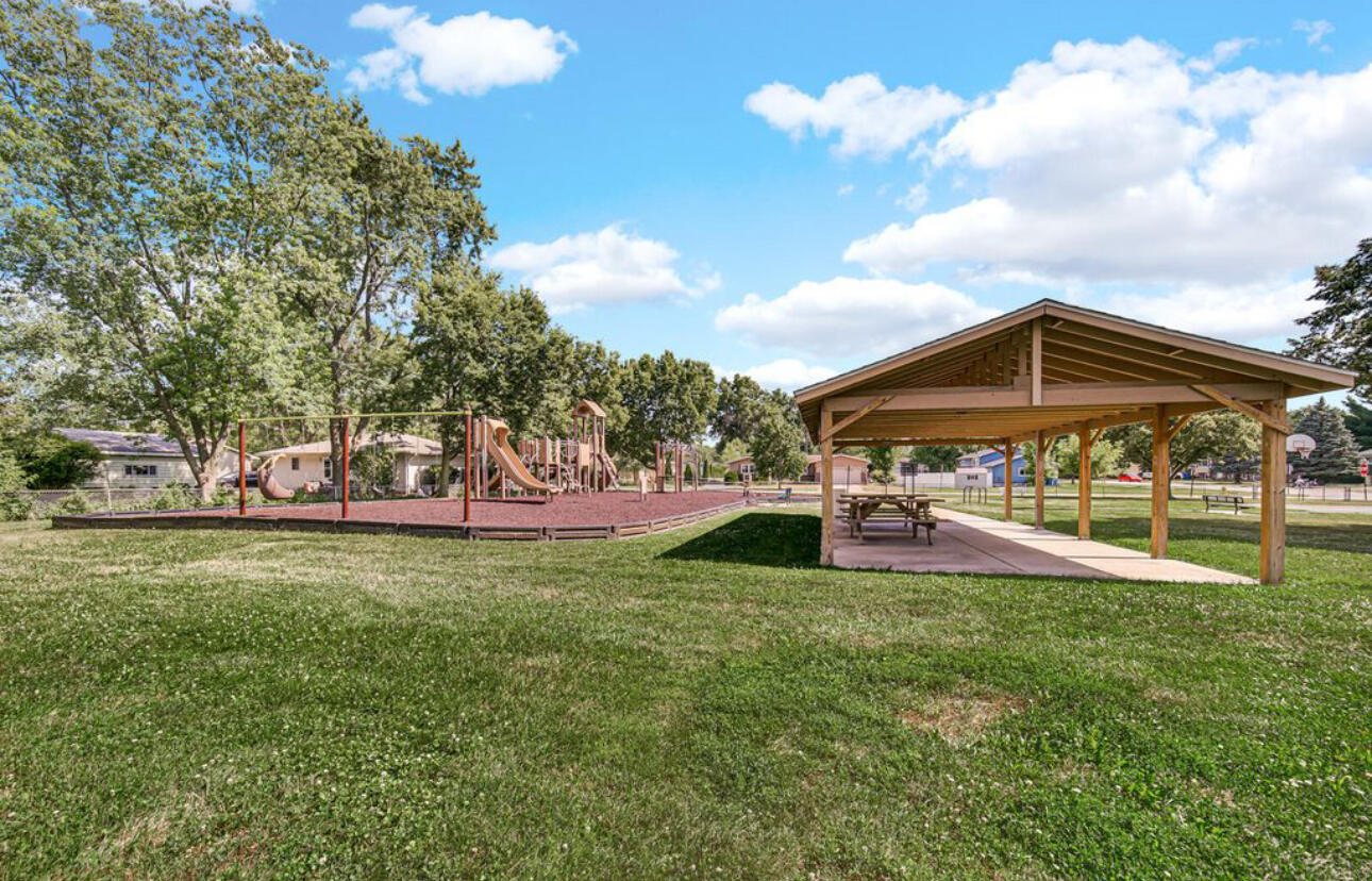 654 Cheyenne Drive Lowell, IN 46356 - Photo 11 of 11 a view of a house with a big yard and a large tree