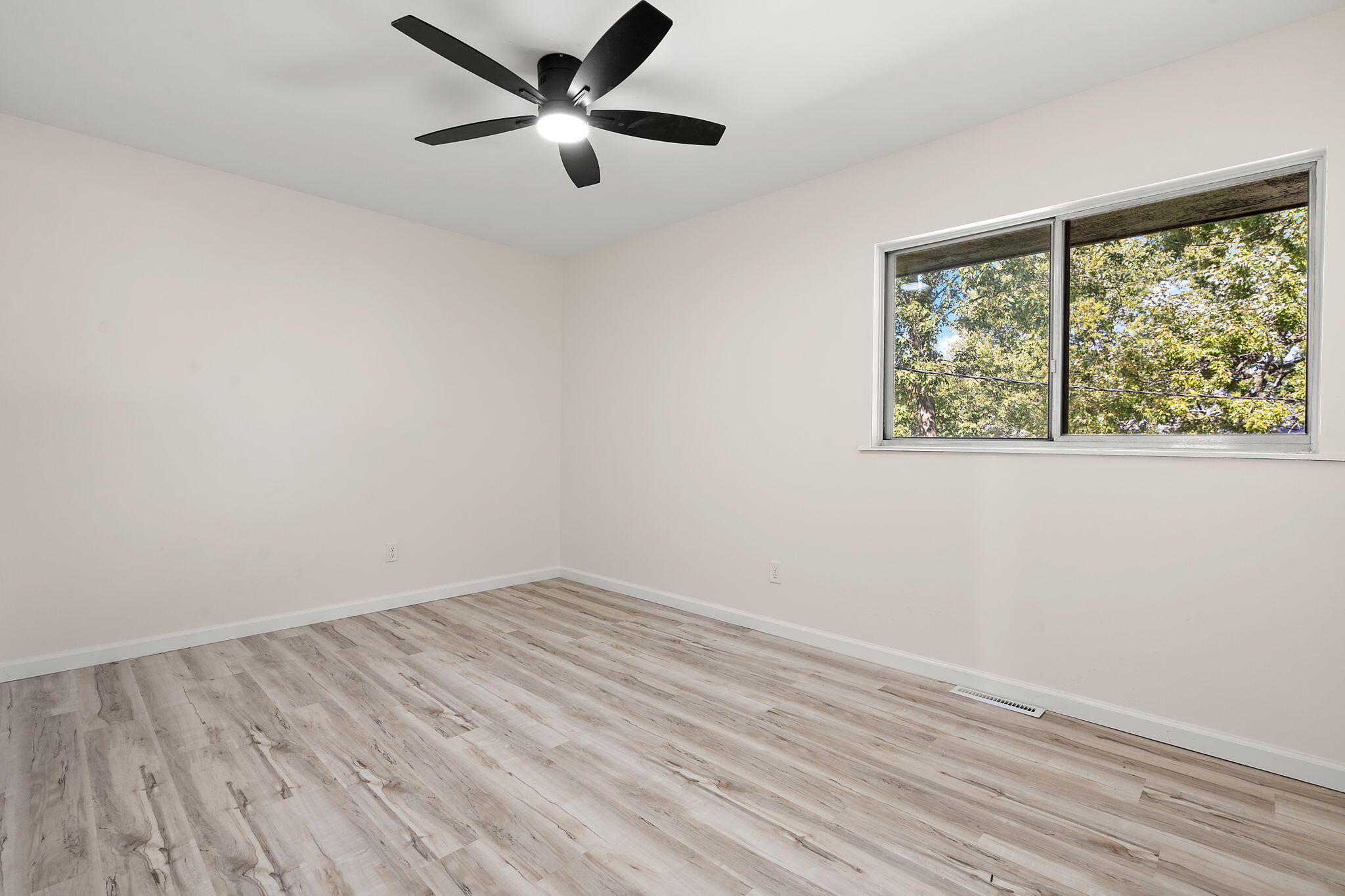 654 Cheyenne Drive Lowell, IN 46356 - Photo 6 of 11 wooden floor in an empty room with a window