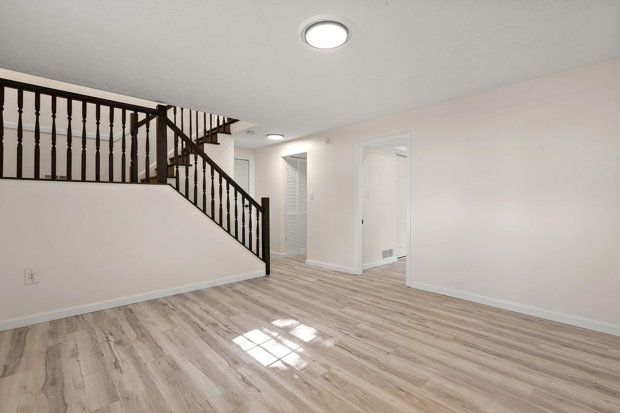 654 Cheyenne Drive Lowell, IN 46356 - Photo 8 of 11 a view of a hallway with wooden floor and staircase