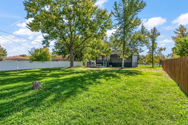 a view of a house with a backyard