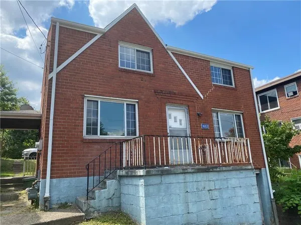 a front view of a house with stairs