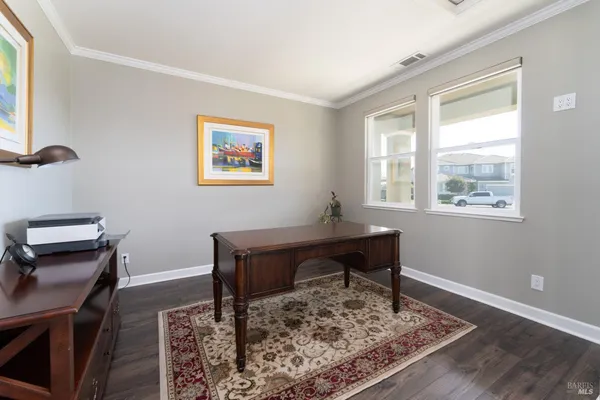 a living room with furniture a rug and a chandelier