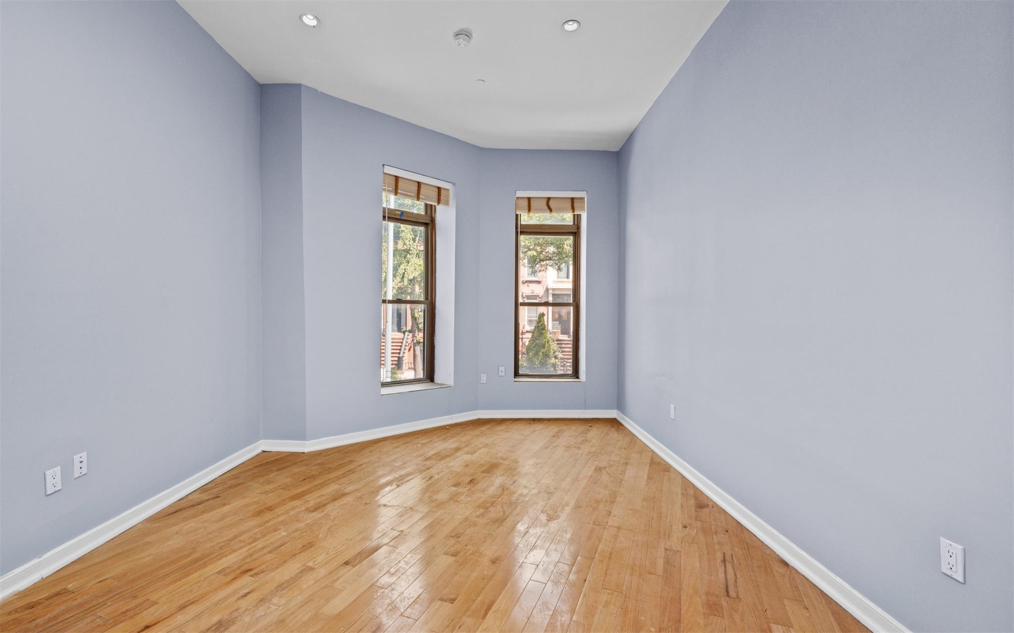 626 Madison Street Brooklyn, NY 11221 - Photo 11 of 42 Spare room featuring light wood-style flooring, baseboards, and recessed lighting