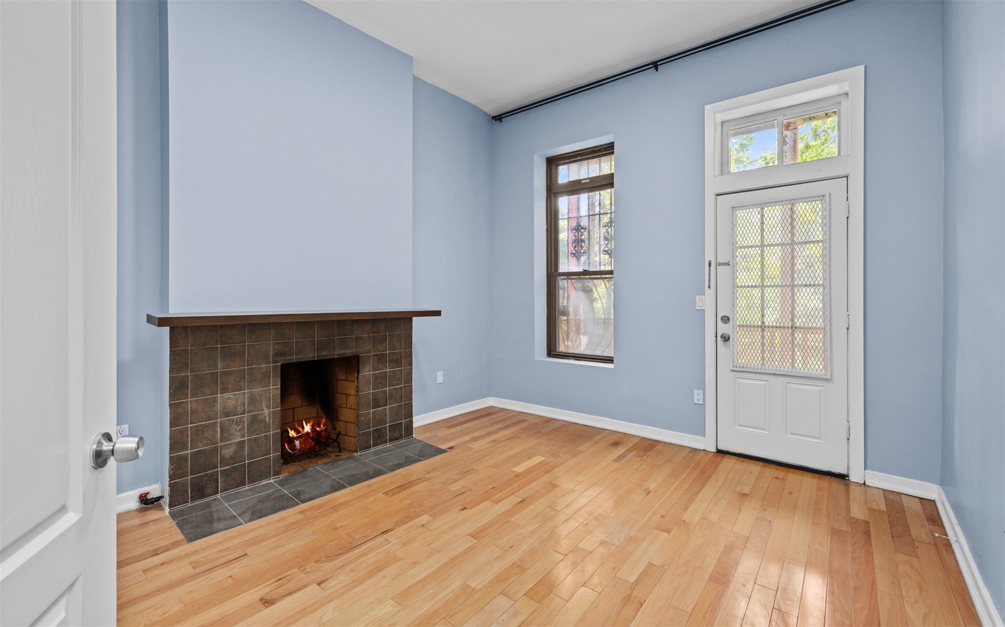 626 Madison Street Brooklyn, NY 11221 - Photo 18 of 42 Foyer with a tiled fireplace, wood finished floors, and baseboards