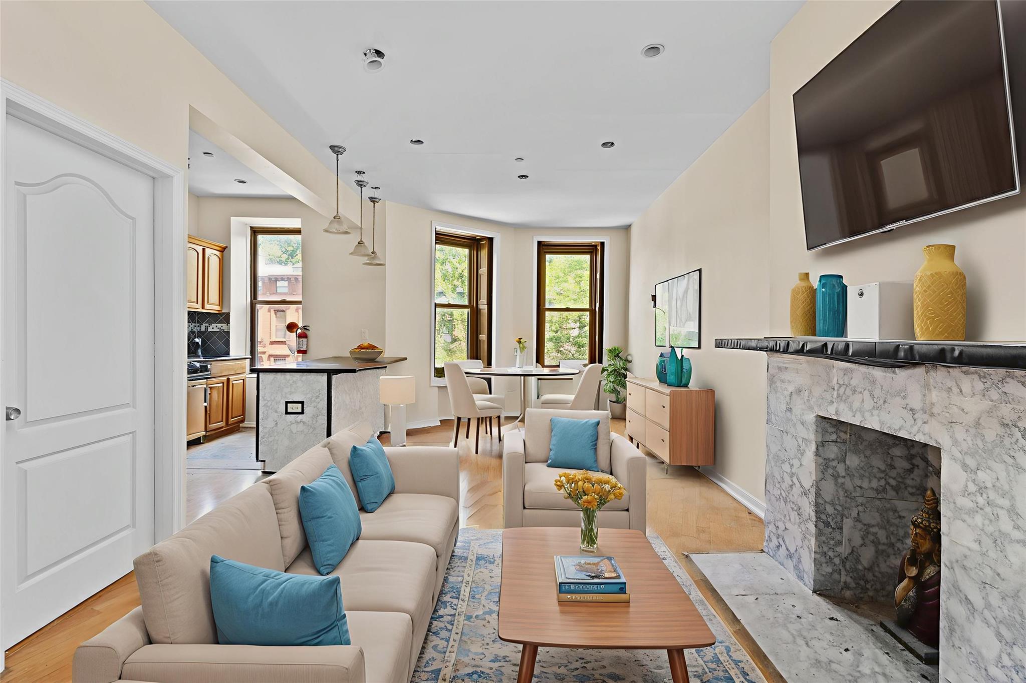 626 Madison Street Brooklyn, NY 11221 - Photo 21 of 42 Living area featuring light wood-style floors, a premium fireplace, baseboards, and recessed lighting