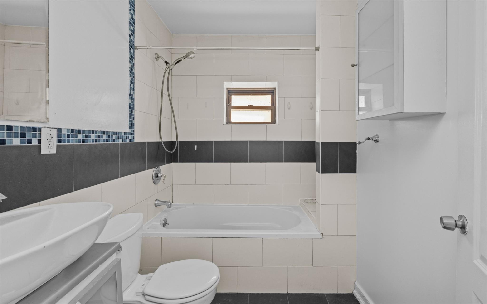 626 Madison Street Brooklyn, NY 11221 - Photo 37 of 42 Full bathroom featuring toilet, tiled shower / bath, and vanity