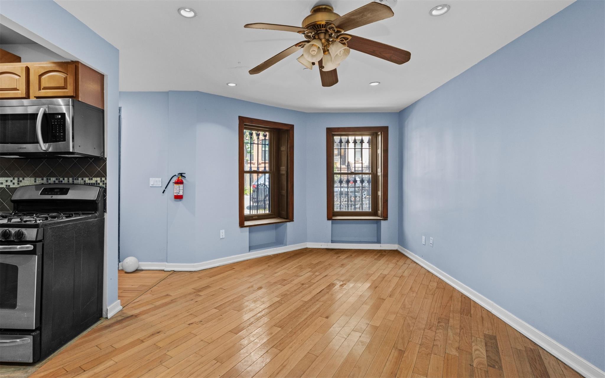 626 Madison Street Brooklyn, NY 11221 - Photo 4 of 42 Kitchen featuring stainless steel appliances, baseboards, ceiling fan, backsplash, and recessed lighting